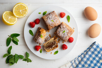 Miguelitos are typical pastries from Spain made from puff pastry. Top view table with  decoration.