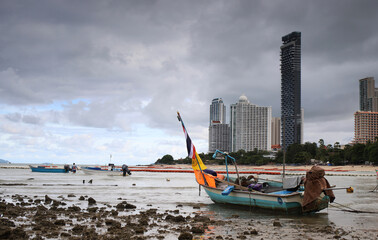 fishing boats in the sea against the background of high-rise modern buildings