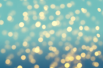 Bright golden Christmas lights on a green blue background. Sparkling gold glittering Christmas lights