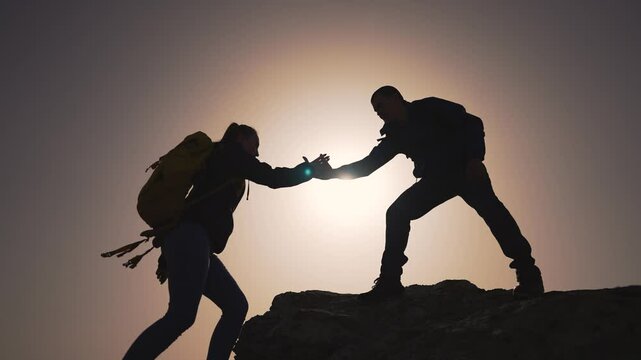 Team reaches summit concept success. Supportive teamwork silhouette against sun. Success adventure team concept strong. Climbers embody team success concept. Teamwork success peak empowering concept.