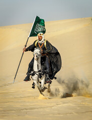Arabian Warrior, riding his white stallion with Saudi Arabian flag in the empt quarter desert