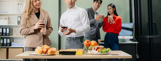 Young Asian Professionals Celebrating with Pizza and Drinks in a Modern Office Setting