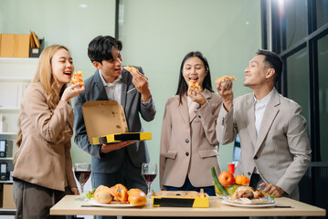 Young Asian Professionals Celebrating with Pizza and Drinks in a Modern Office Setting