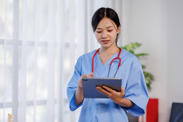 Smiling female nurse or 
doctor healthcare worker in blue scrubs holding a digital tablet, perfect for telehealth or medical technology themes 
