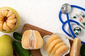Fresh pomelo fruit and medicine adverse drug reaction interaction design concept.