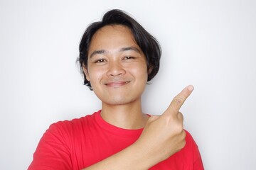 Portrait of an Indonesian man with long hair with a headband and red shirt celebrating Indonesian Independence Day with high nationalism on an isolated white background
