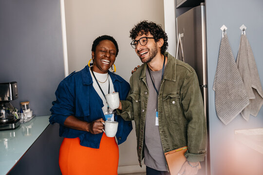 Office breakroom culture with colleagues enjoying coffee and conversation