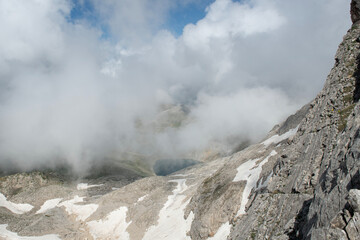 Uludağ glacial lakes. Snowy lake view in cloudy and sunny weather. Lake view in snowy foggy weather. Mountain view covered with blue clouds and snow. Uludağ peak. Bursa, Türkiye.
