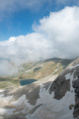 Uludağ glacial lakes. Snowy lake view in cloudy and sunny weather. Lake view in snowy foggy weather. Mountain view covered with blue clouds and snow. Uludağ peak. Bursa, Türkiye.
