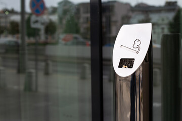 Modern street ashtray with built in hole in metal post, conditions for smokers, not to litter with...