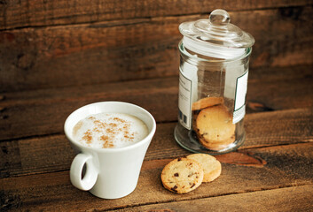 Delicious coffee and cookies, on a wooden background