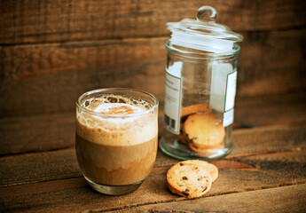 Delicious coffee and cookies, on a wooden background