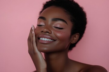 A woman with a soft smile, her hand gracefully touching her face, set against a pastel pink