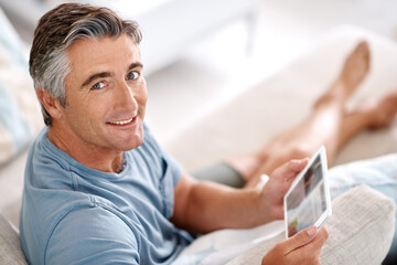 Tablet, sofa and portrait of mature man for online chatting, communication and networking. Living room, home and happy person on digital technology for internet news, website and relax on weekend