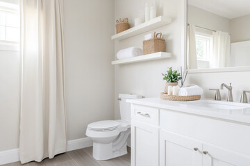 Fototapeta premium Modern minimalist bathroom featuring white cabinets, floating shelves, woven baskets, natural light, and soft neutral tones for a clean look
