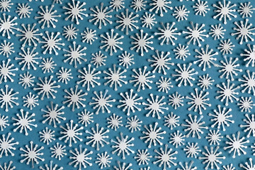 Blue background with white paper snowflakes. Winter background.