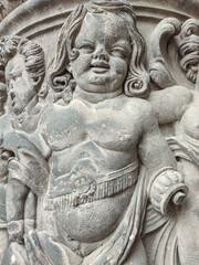 Dresden, Germany, old art sculptures, column stucco molding  of young boys as angels, slaves and soldiers, gatekeepers