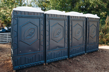 four street toilets on ground, WC in summer park