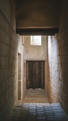 Quiet Stone Corridor with Wooden Door and Light Window