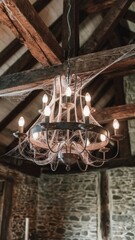 Fototapeta premium Rustic Chandelier Hanging in a Wooden Ceiling Loft