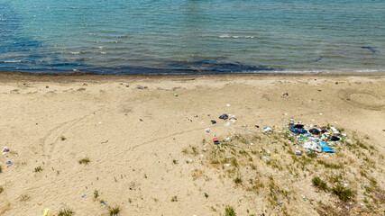 Aerial view of a sandy beach polluted and full of waste. Pollution concept.