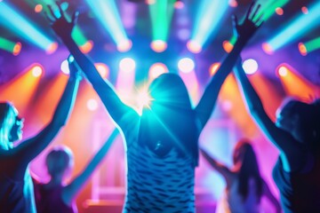 A spirited group of young people dance excitedly as colorful lights pulse around them, creating an...