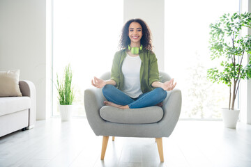 Photo of attractive cute girl wear stylish clothes mediate relax rest enjoy comfortable flat living room daylight indoors