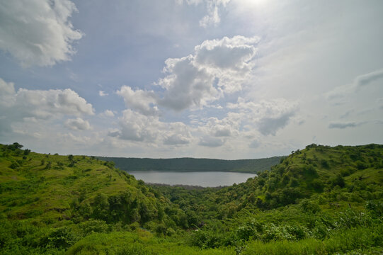 Faraway view of Lonar crater lake under cloudy skies, Maharashtra, India.