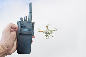 Military soldier  quadcopter transmits the coordinates of the drone over the radio to adjust the...