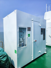 Compact Utility Container on a Ship's Deck Overlooking the Sea