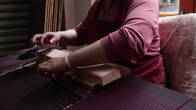Woman manufacturing Incense sticks in Nado Poizokhang Thimphu, Bhutan