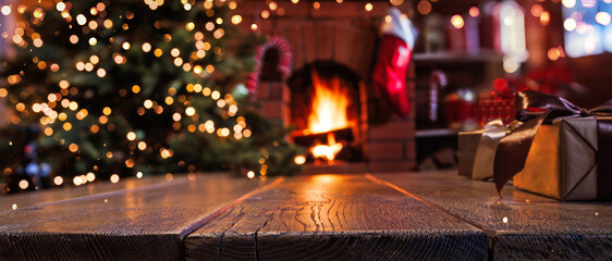 Christmas tree with decorations near fireplace with fire. Holiday background with gifts on wooden...