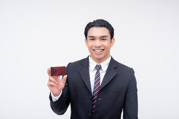 A confident young asian business executive smiling while presenting a blank card. Possible reward, membership or debit card. Isolated on a white background.