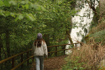 Young Woman Hiker on the Ribasieira Trail Surrounded by Lush Greenery