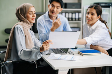 Fototapeta premium Happy businesspeople while collaborating on a new project in an office.