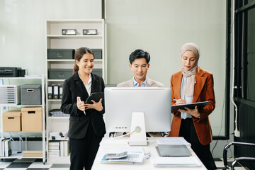  Asian businesspeople while collaborating on a new project.  using a laptop and tablet
