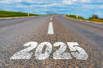 The goal word calendar 2025 written on highway road in the middle of empty asphalt road at golden...