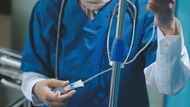 Woman doctor monitor Adjust the drip rate feed of saline dripping intravenous infusion to patient on bed. IV tube or intravenous infusion tube have Sodium Chloride Solution fine tune by doctor.