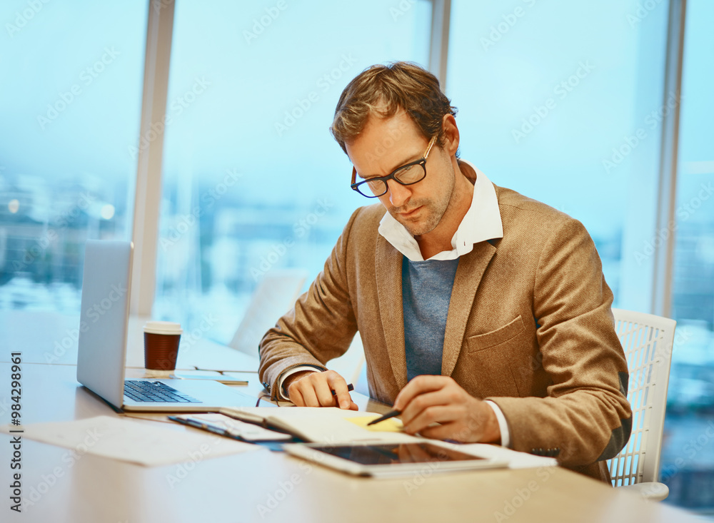 Poster man, laptop and writing with notes, documents and tablet for connection at digital agency as art dir