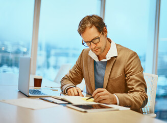 Man, laptop and writing with notes, documents and tablet for connection at digital agency as art...