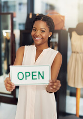 Owner, woman and portrait with open sign in store for welcome, ready for service and small business. Entrepreneur, poster board and start day at boutique door in startup shop for fashion and clothing