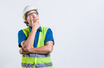 Pensive builder man with hand on chin isolated. Young builder wondering looking up with hand on chin