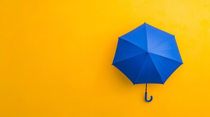 Obraz premium A concept of summer and rain protection with a blue umbrella held high, popping against a vivid yellow background.