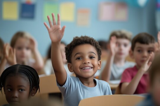 Cheerful diverse primary school children students in modern light classroom with one hand up to asnwer teacher's question
