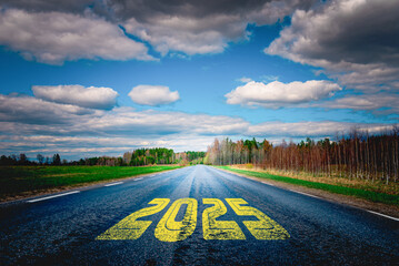 The goal word calendar 2025 written on highway road in the middle of empty asphalt road at golden...