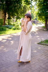 plus size woman in peach fuzz dress with hat having fun on morning city streets