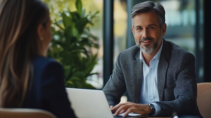 Fototapeta premium Lawyer or real estate agent make consultation for client Mature Latin business man and European business woman discussing project on laptop sitting at table in office Business people w : Generative AI