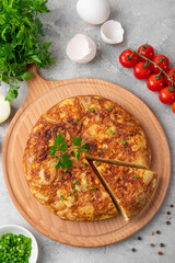 Spanish omelette tortilla with potatoes and onion on a stone background. Spanish cuisine. Top view.