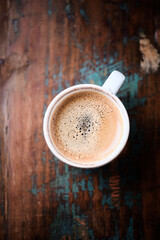 Cup of coffee on wooden background. Close up.	