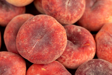 a pile of ripe washed peaches on the table